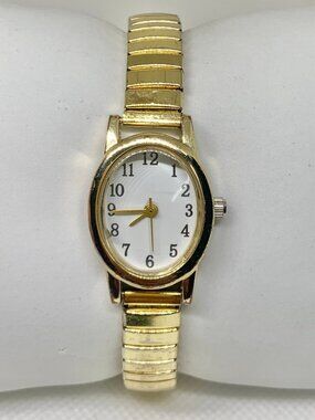 FMD gold tone women’s watch oval case 19mm quartz stretch band size 7” running